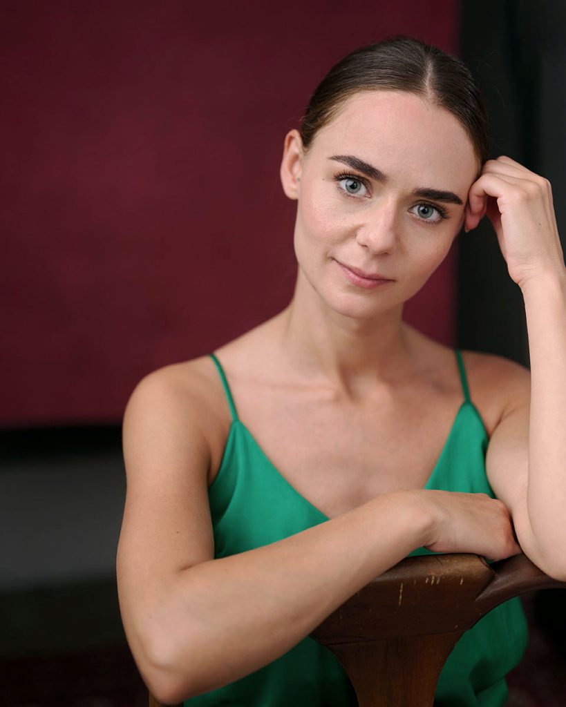 actress in green top and slicked back hair creatively captured by jacqui mcsweeney