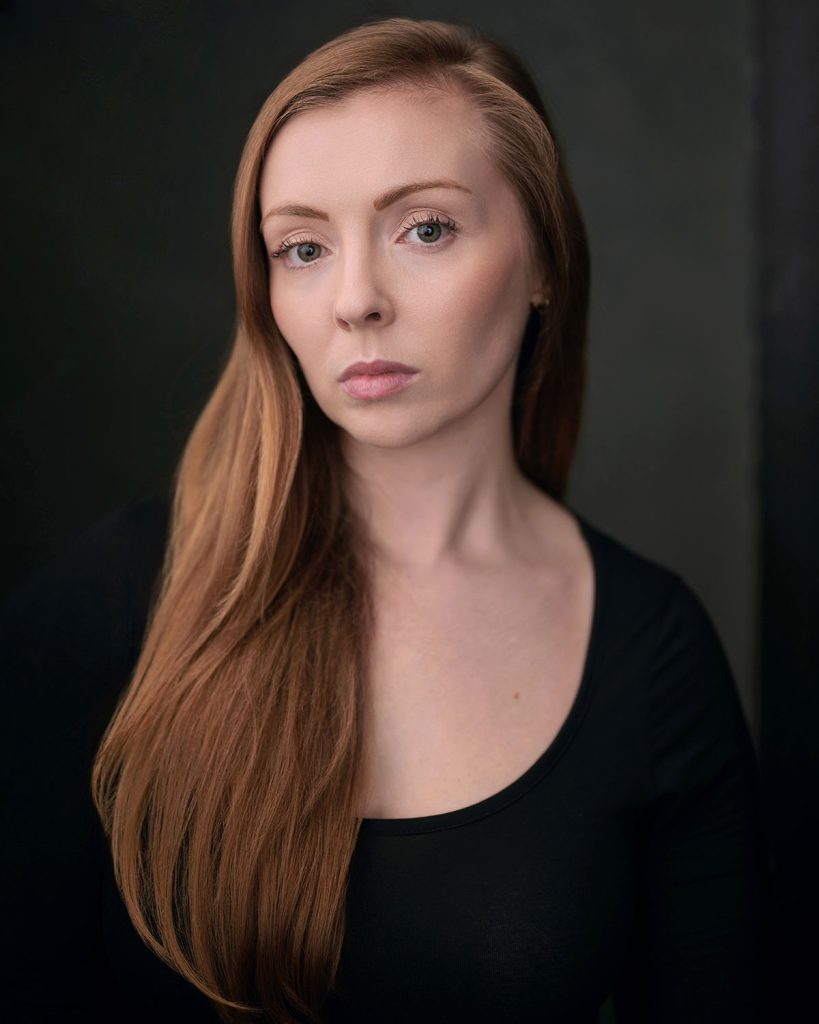 Sarah Milton in headshot photography, wearing a dark background in the Brighton studio.
