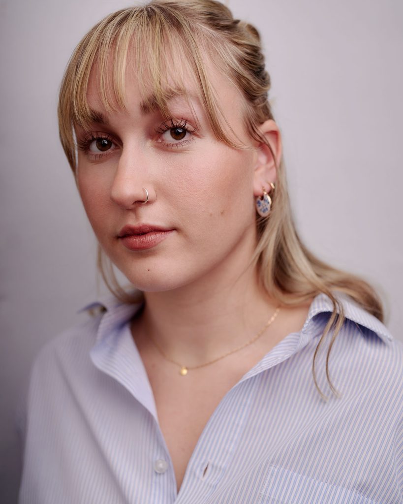Lily Merchant in blue shirt by Headshot Photographer Jacqui McSweeney © 2024.