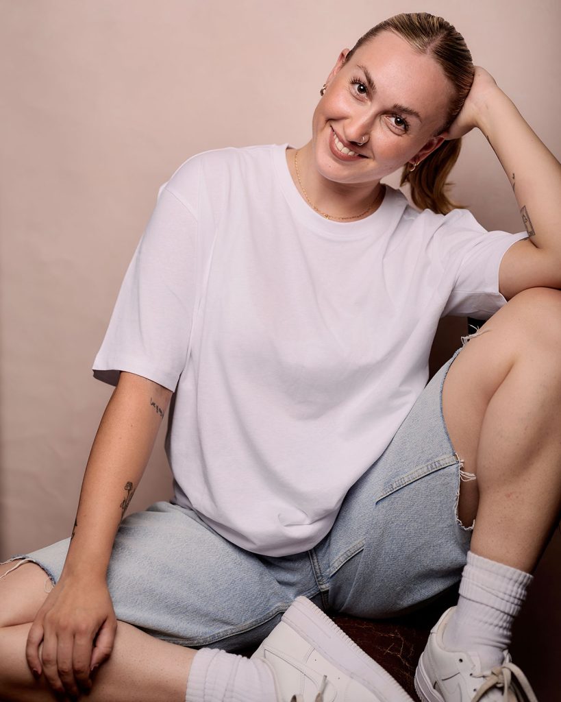 Lily Merchant in casual outfit, shorts and t-shirt by Headshot Photographer Jacqui McSweeney © 2024